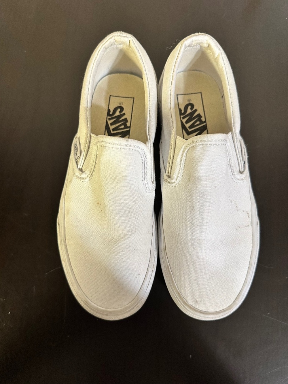 These are white Vans Classic Slip-On Platform shoes with white canvas uppers.